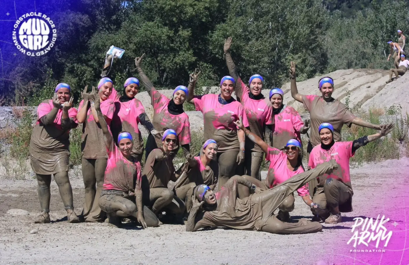 L'équipe Walgym couverte de boue après la Mudgirl Run, bras levés et sourires